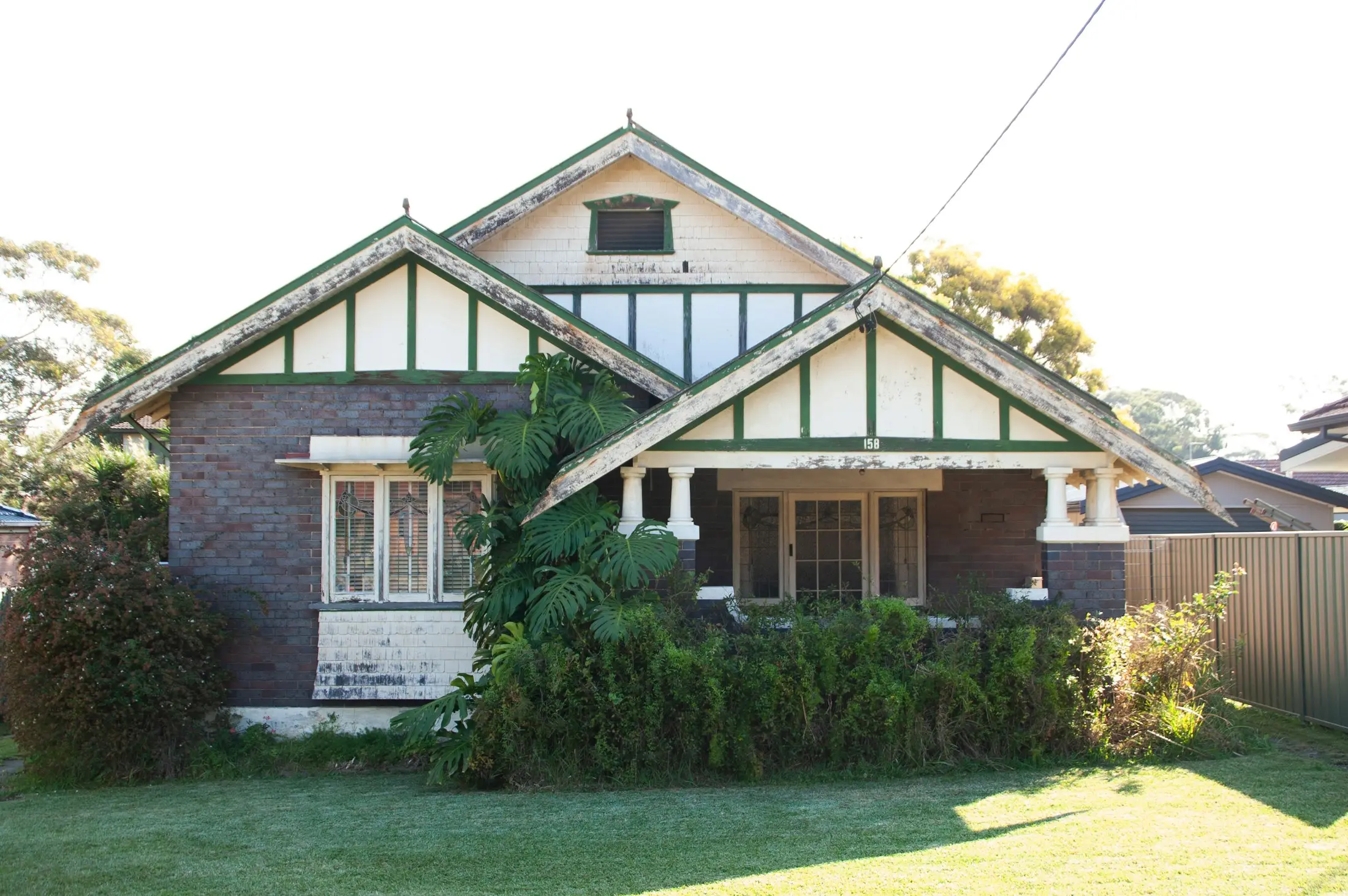 Classic Australian fibro house behind a front fence, ready for a renovation