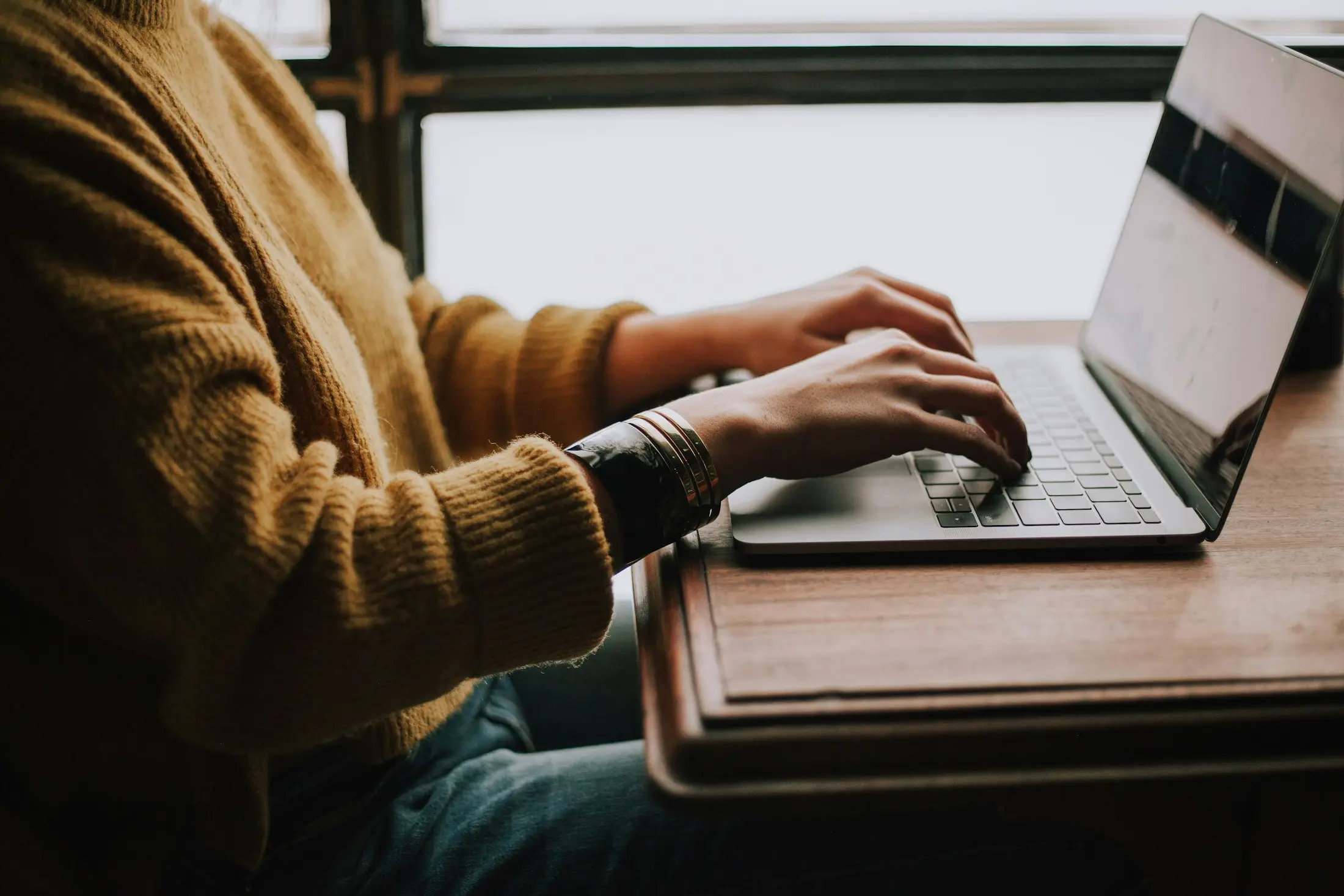 Person typing on a laptop at a desk