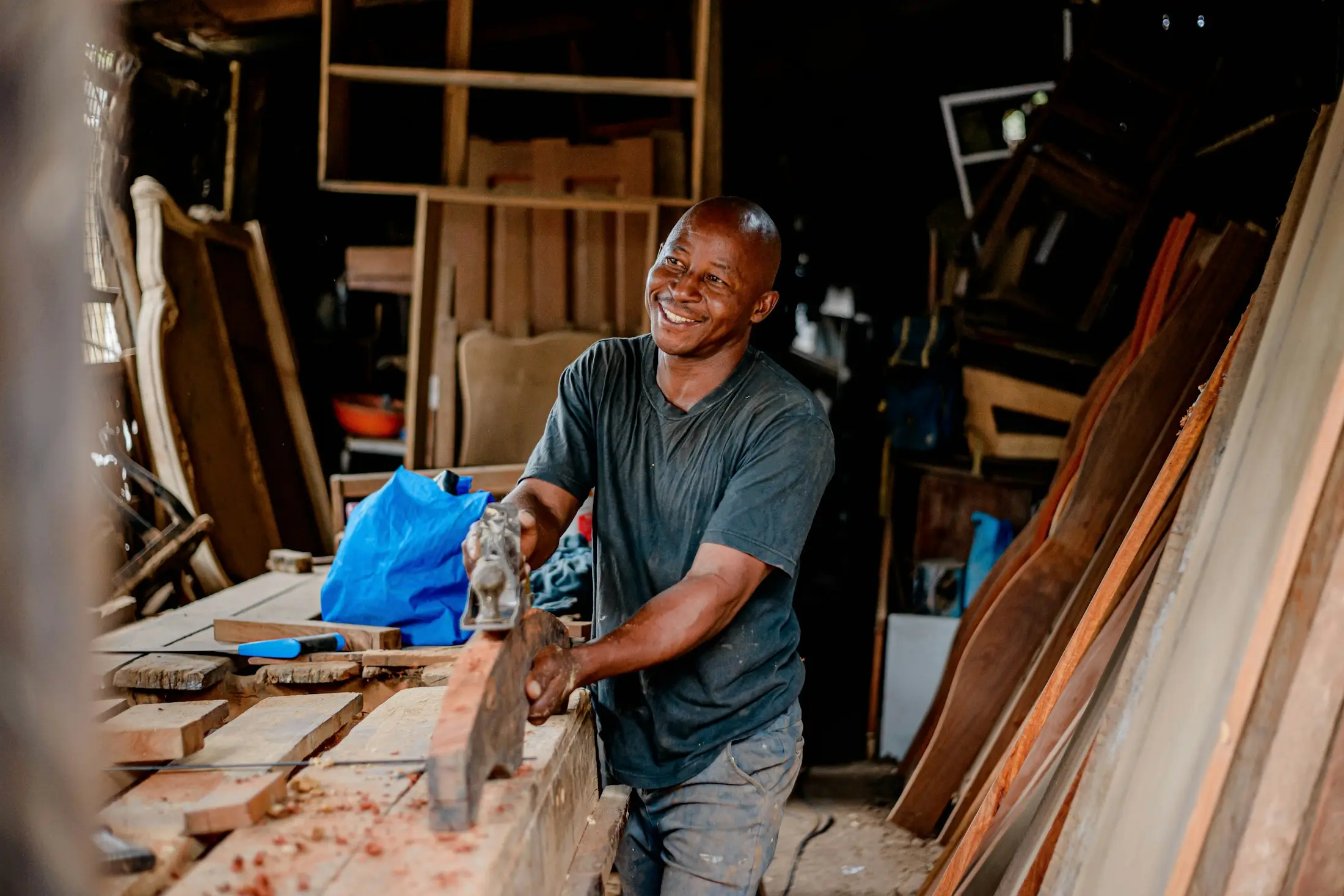Woodworker measuring timber in his new workshop