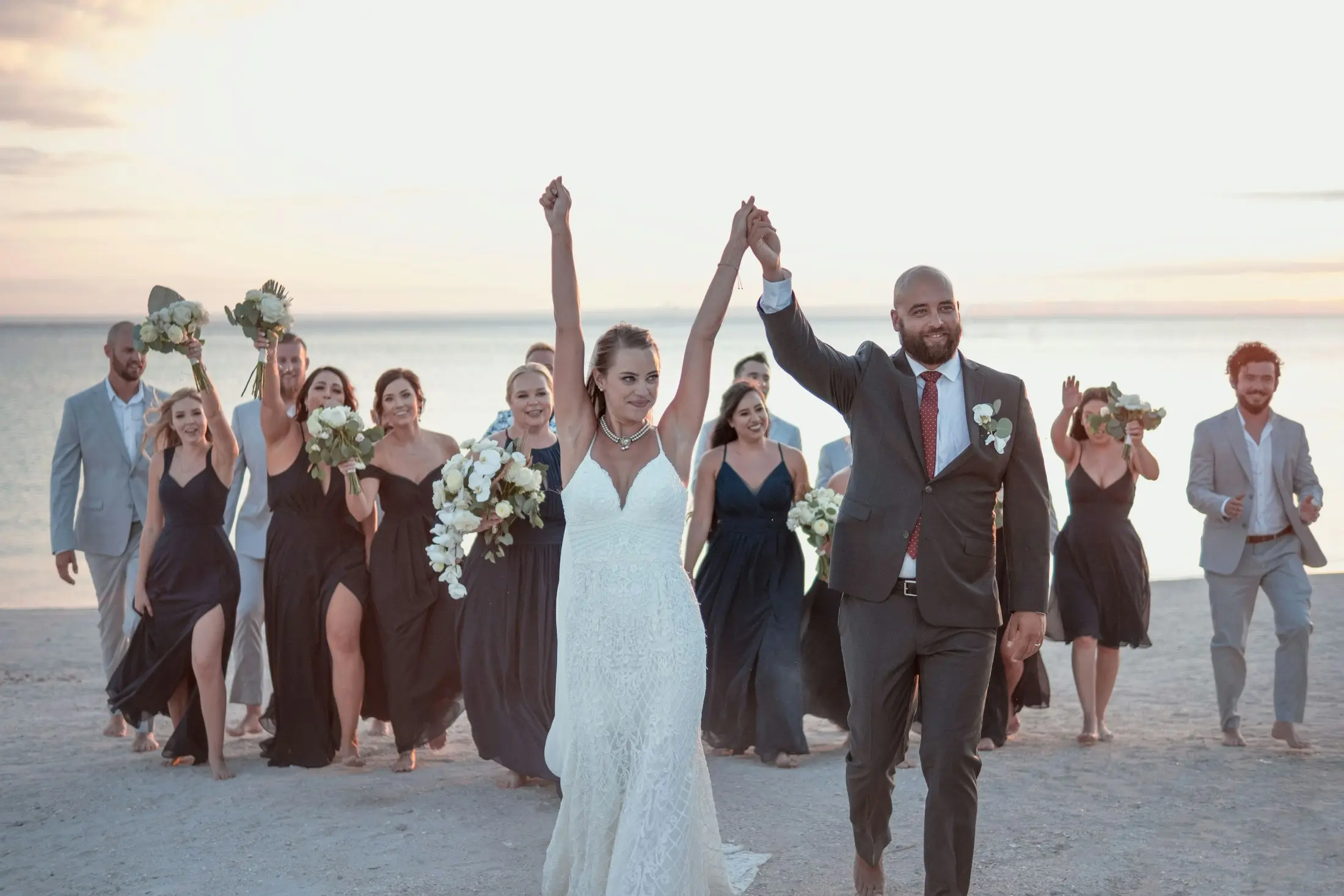 Wedding party celebrating on the sand